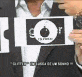 a man in a suit is holding a card that says to fora