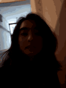 a close up of a woman 's face with a blurred background