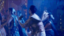a blurry picture of a group of people dancing in a dark room .