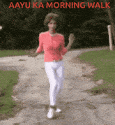 a woman is walking down a road with the words aayu ka morning walk written above her