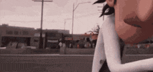 a close up of a person 's face while standing on the side of a street .