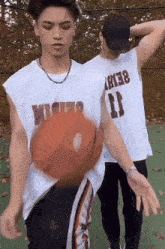 a man wearing a number 11 shirt is playing basketball