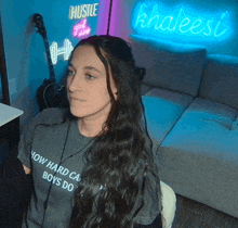 a woman wearing a t-shirt that says " how hard can boys do "