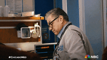a man in a chicago medical center uniform looks down