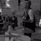 a man playing a guitar in front of a drum set that says zildjian
