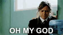 a woman standing next to a water cooler with the words oh my god written on it .