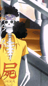 a skeleton is wearing a yellow shirt with shika bane written on it