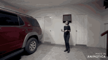 a woman is standing in a garage next to a red suv and the words made in animatica on the bottom