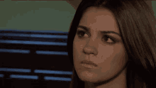 a close up of a woman 's face with a serious expression