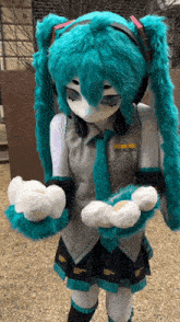 a person in a vocaloid costume is holding something