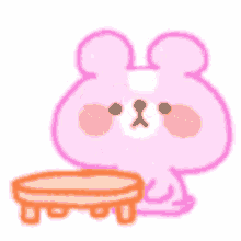 a pink teddy bear is holding a cup in its hand .
