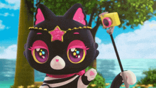 a black cat with a pink star on its head holds a camera