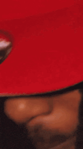 a close up of a person 's face with a red hat