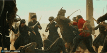 a group of men are fighting with swords and the words pranay varma are on the bottom of the screen