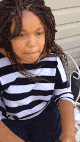 a girl wearing a black and white striped shirt