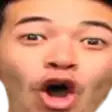 a man is making a surprised face with his mouth open .