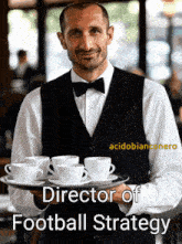 a man in a vest and bow tie holds a tray of coffee cups with the caption director of football strategy