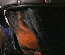 a close up of a woman 's face with a black mask on