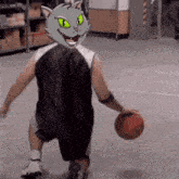 a basketball player with a cat mask on his head dribbles the ball