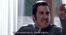 a man in a suit and tie is yelling at someone .