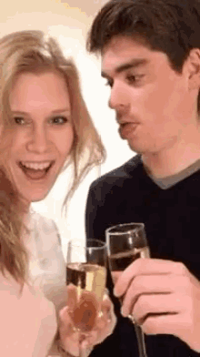 a man and a woman are toasting with glasses of champagne