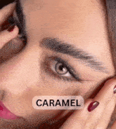 a close up of a woman 's face with the word caramel above her eyes