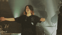 a woman in a black shirt with the letter d on the bottom