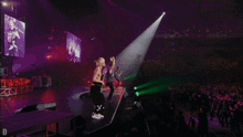 a group of people on a stage with a screen behind them that says ' x ' on it
