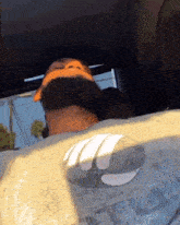 a man wearing a gray shirt with a batman logo