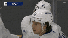 a hockey player wearing a number 23 helmet