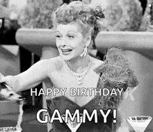 a black and white photo of a woman sitting at a table holding a martini glass and saying `` happy birthday gammy ! ''