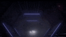 a dark room with a few lights shining through the ceiling