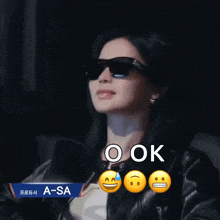 a woman wearing sunglasses and a jacket with a sticker that says a-sa on it