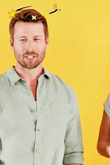 a man with a beard wearing a green shirt is smiling with a yellow background
