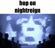 a group of people are standing in front of a projection of a man 's face .