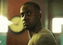 a man is standing in front of a clock in a room .
