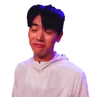 a young man wearing a white nike jacket makes a funny face