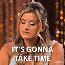 a woman says " it 's gonna take time " in front of a blurred background