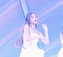 a woman in a white dress is giving a thumbs up