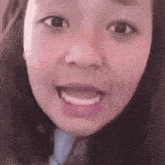 a close up of a woman 's face with her mouth open and teeth showing