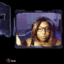 a woman wearing glasses and headphones is on a video screen