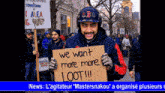 man holding a sign that says we want more more loot