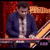 a man is playing a keyboard on a stage .