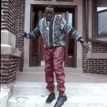 a man is standing on a set of stairs in front of a building .