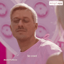 a man in a pink shirt says " so cool " in front of a pink background