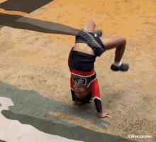 a cheerleader is doing a handstand with the number 3 on her top
