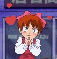 a girl with red hair and a pink bow on her head stands in front of a sign that says ' a ' on it