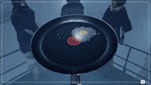 a frying pan with a fried egg and a slice of meat in it