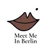 a logo that says meet me in berlin with a brown lip