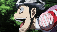a close up of a person wearing a helmet and a shirt with the letter k on the arm